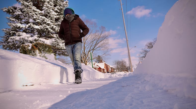 Matt Johnson takes a walk down Harding Road in Springfield, one of the few areas where sidewalks were cleared of snow as of Monday afternoon, Jan. 26, 2026. MARSHALL GORBY / CONTRIBUTED