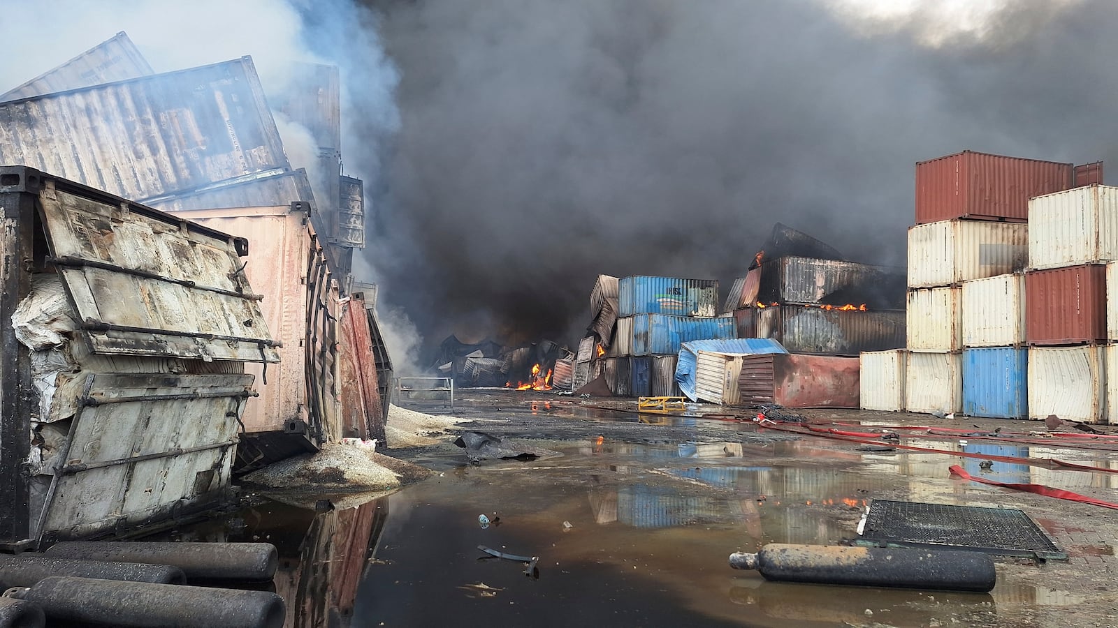 Containers burn, Sunday, April 27, 2025, after a massive explosion and fire rocked a port near the southern port city of Bandar Abbas, Iran, on Saturday. (AP Photo/Meysam Mirzadeh/Tasnim News)