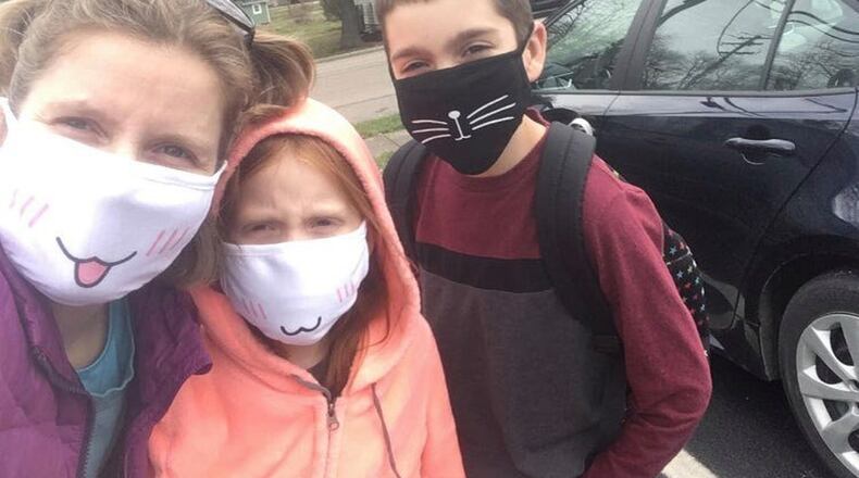 Many Ohioans in the last week have received notice that they are to start working remotely, and that schools will be out of session for weeks in light of the coronavirus pandemic, and that means a self-quarantine at home. Jenny Schumacher, her daughter Cady and son, Josiah, show the sign of the times as they get outside to get some fresh air.