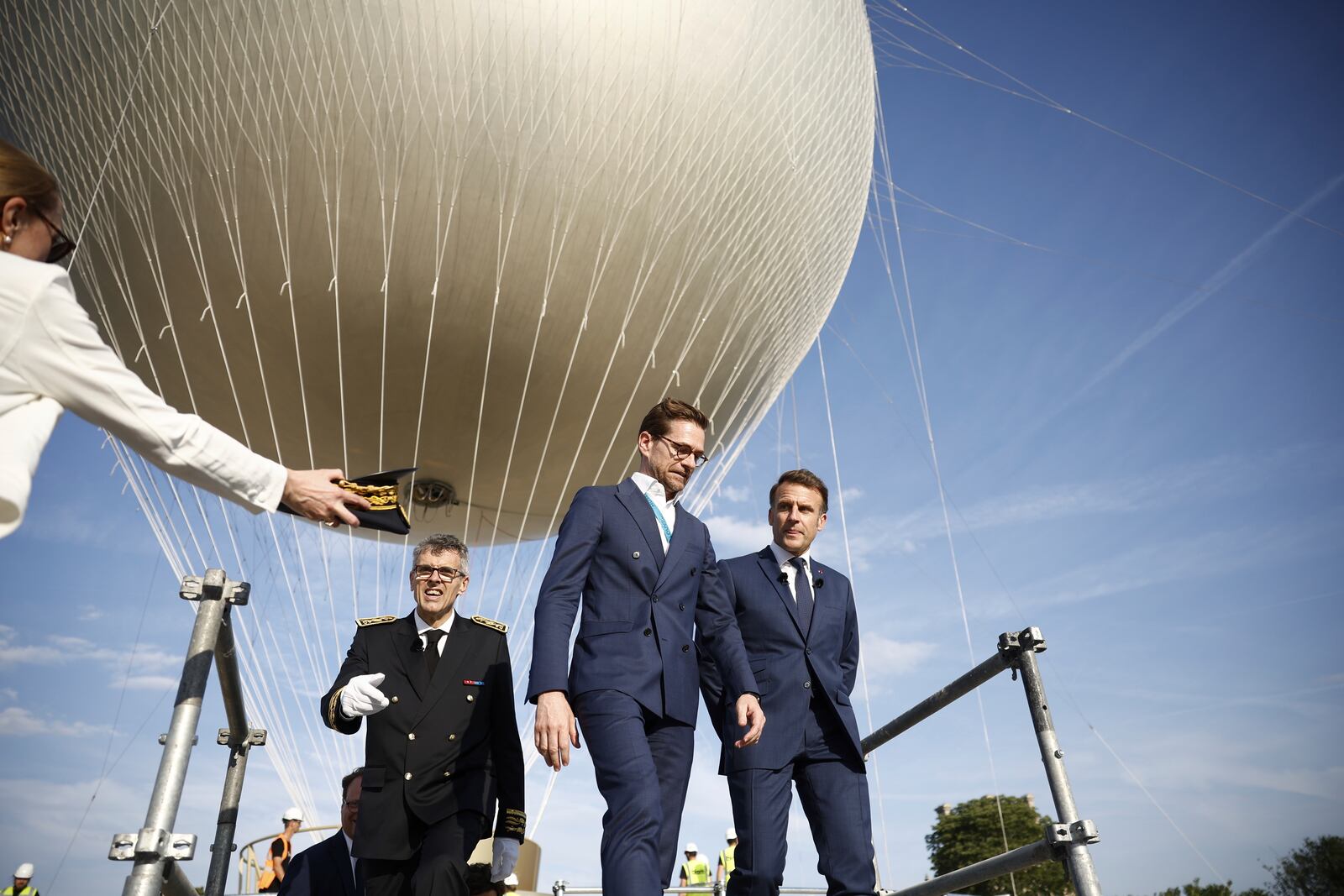 French President Emmanuel Macron, right, visits the site of the reinstallation of the Olympic cauldron at the Tuileries Garden in Paris, Thursday, June 12, 2025. (Yoan Valat/Pool Photo via AP)