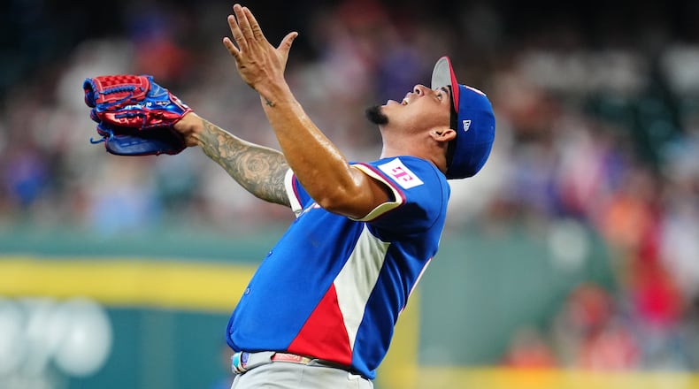 Puerto Rico pitcher Eduardo Rivera celebrates after striking out Italy's Vinnie Pasquantino during the second inning of a World Baseball Classic quarterfinal game, Saturday, March 14, 2026, in Houston. (AP Photo/Karen Warren)
