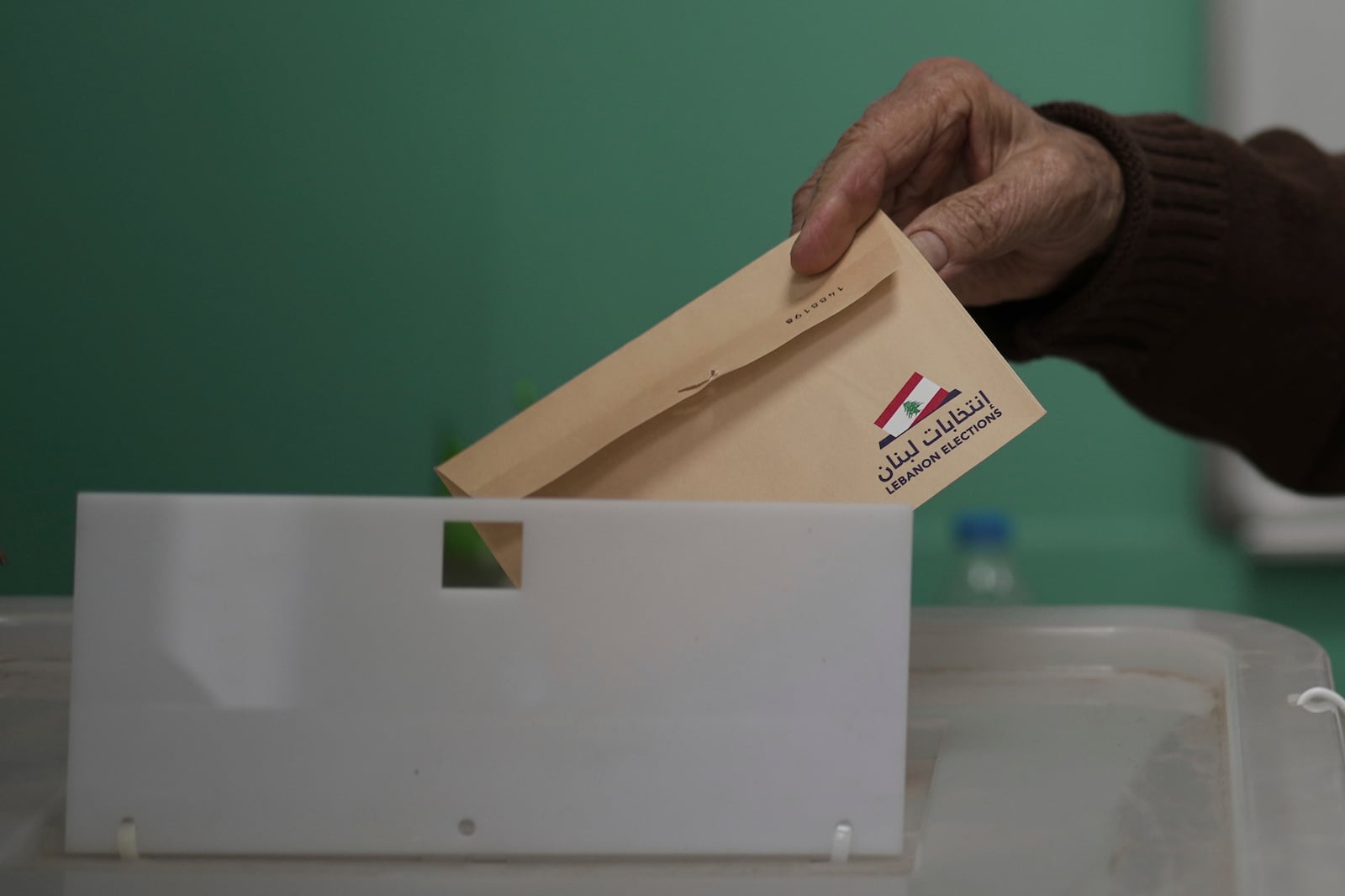 A Lebanese man casts his ballot at a polling station during municipal elections in the southern suburbs of Beirut, Lebanon, Sunday, May 4, 2025. (AP Photo/Hassan Ammar)