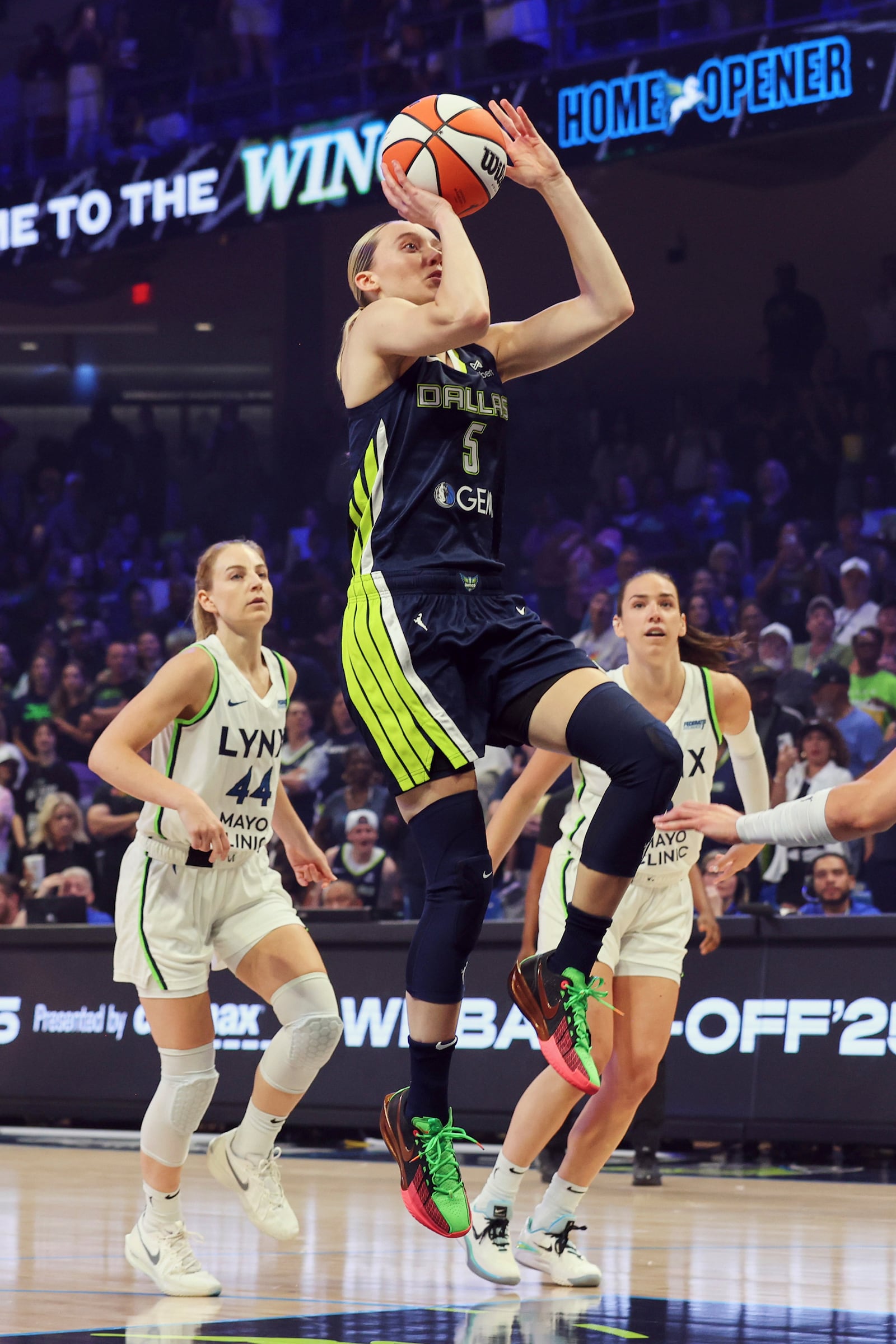Dallas Wings guard Paige Bueckers (5) shoots after getting past Minnesota Lynx's Karlie Samuelson (44) in the first half of a WNBA basketball game Friday, May 16, 2025, in Arlington, Texas. (AP Photo/Richard Rodriguez)