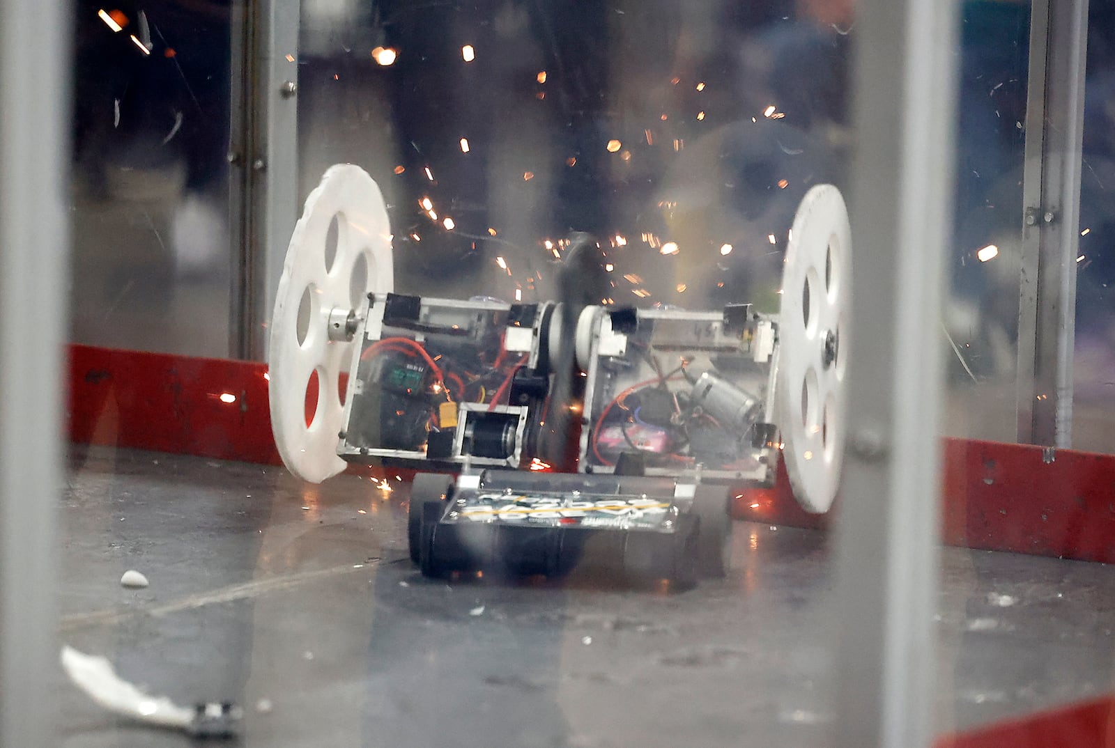 Sparks fly as two bots in the 15 pound class smash into each other during the Xtreme Bots and Xtreme Drone Soccer competition Saturday, March 23, 2024 at the Clark County Fairground. The event featured teams of middle school, high school and even college students battling in different weight classes with their customized remote-controlled robots and drones. The competitions are under the Xtreme STEM organization, which has several programs including BOTS and drones, to get middle and high school students involved in STEM. There were two Clark County teams in the competition, one from Hayward Middle School and one from Cliff Park High School. BILL LACKEY/STAFF