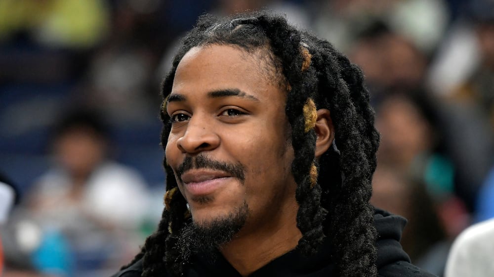 Memphis Grizzlies guard Ja Morant looks on from the bench in the first half of an NBA basketball game against the Portland Trail Blazers, Wednesday, March 4, 2026, in Memphis, Tenn. (AP Photo/Brandon Dill)