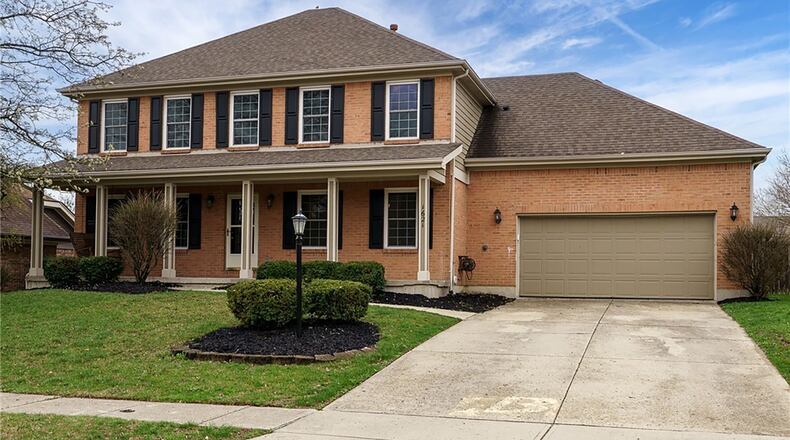 The brick and siding two story in Vandalia has a covered front porch and two car attached garage.