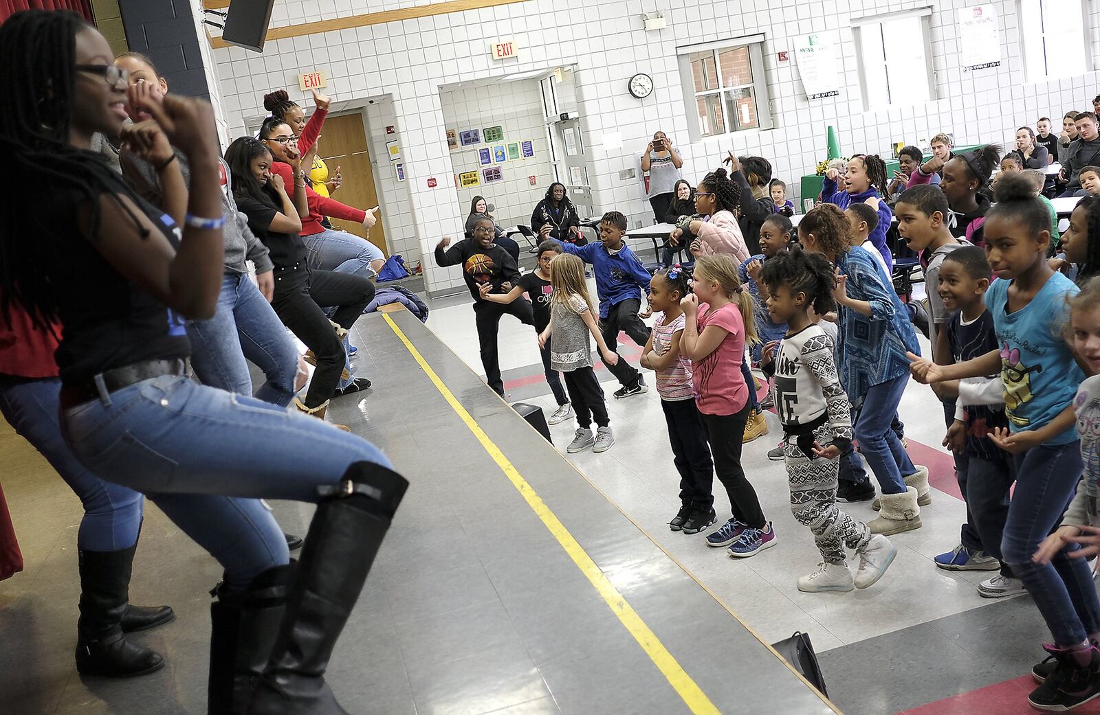 Children in the Lincoln Elementary Promise Neighborhood program try to keep up with a group of Wilberforce University fraternity and sorority members demonstrating “Step Dancing” Wednesday. Bill Lackey/Staff