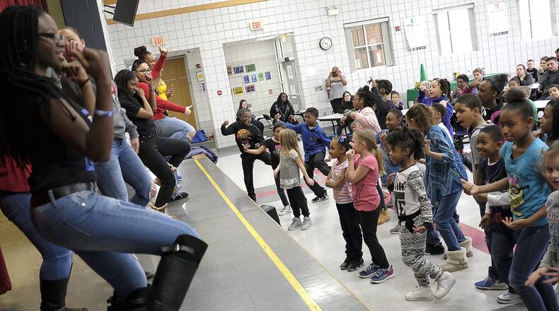 Children in the Lincoln Elementary Promise Neighborhood program try to keep up with a group of Wilberforce University fraternity and sorority members demonstrating “Step Dancing” Wednesday. Bill Lackey/Staff