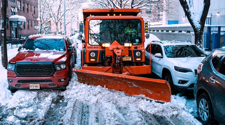 A truck removes snow for them street a day after a winter storm on Tuesday, Feb. 24, 2026, in New York. (AP Photo/Eduardo Munoz Alvarez)