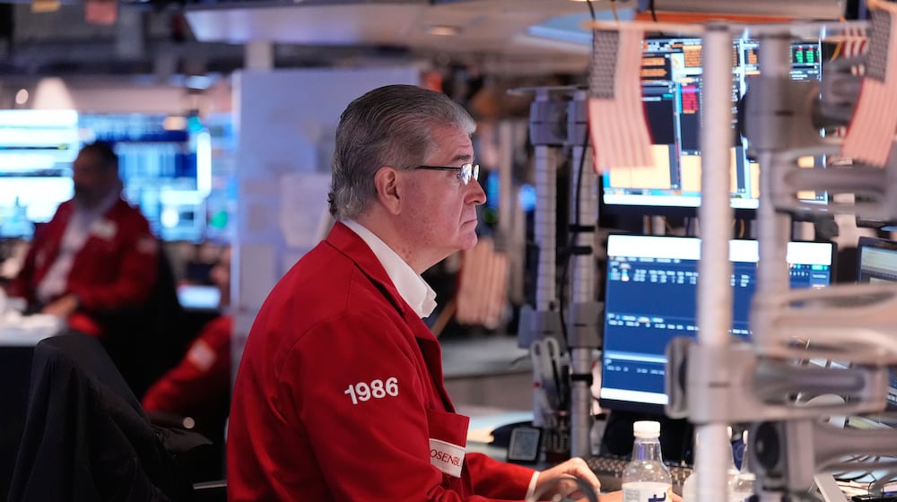 Daniel Kryger works on the floor at the New York Stock Exchange in New York, Thursday, Nov. 13, 2025. (AP Photo/Seth Wenig)