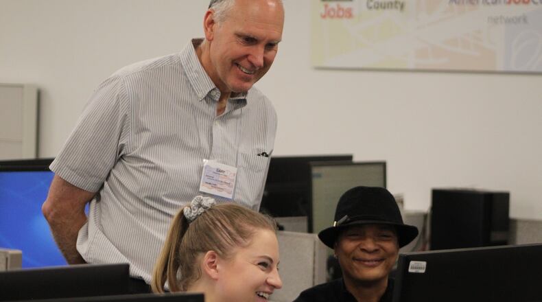 University of Dayton student Claire Vogel helped prepare and submit 58-year-old Teresa Rainey’s tax returns on Saturday at the Job Center. Volunteer Gary Dowdy also helped low- and moderate-income residents file their returns. CORNELIUS FROLIK / STAFF