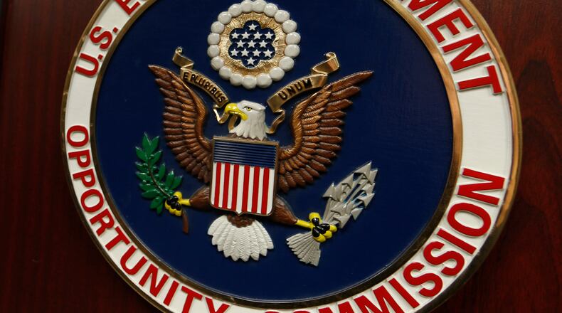 FILE - The emblem of the U.S. Equal Employment Opportunity Commission (EEOC) is displayed on a podium in Vail, Colo., Feb. 16, 2016. (AP Photo/David Zalubowski, File)