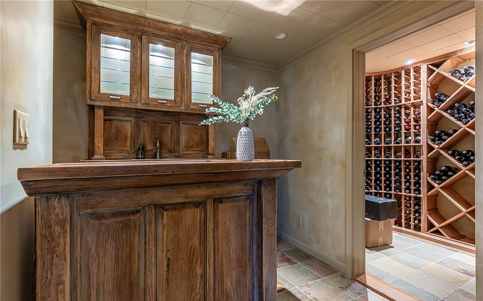 the basement has a wet bar with custom cabinetry and a wine cellar with bottle storage. CONTRIBUTED