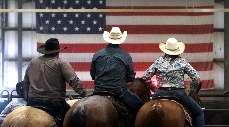 Three competitors in the team ranch sorting competition at the Champions Expo Center in Clark County wait their turn to race against the clock and sort designated calves from the herd. BILL LACKEY/STAFF