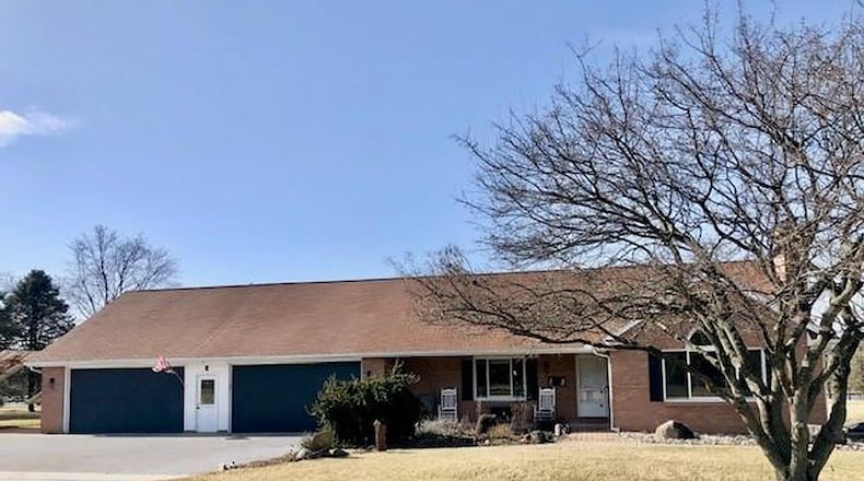 The front of the home features a 4 1/2-car attached garage with double doors and a covered front porch. Contributed photos