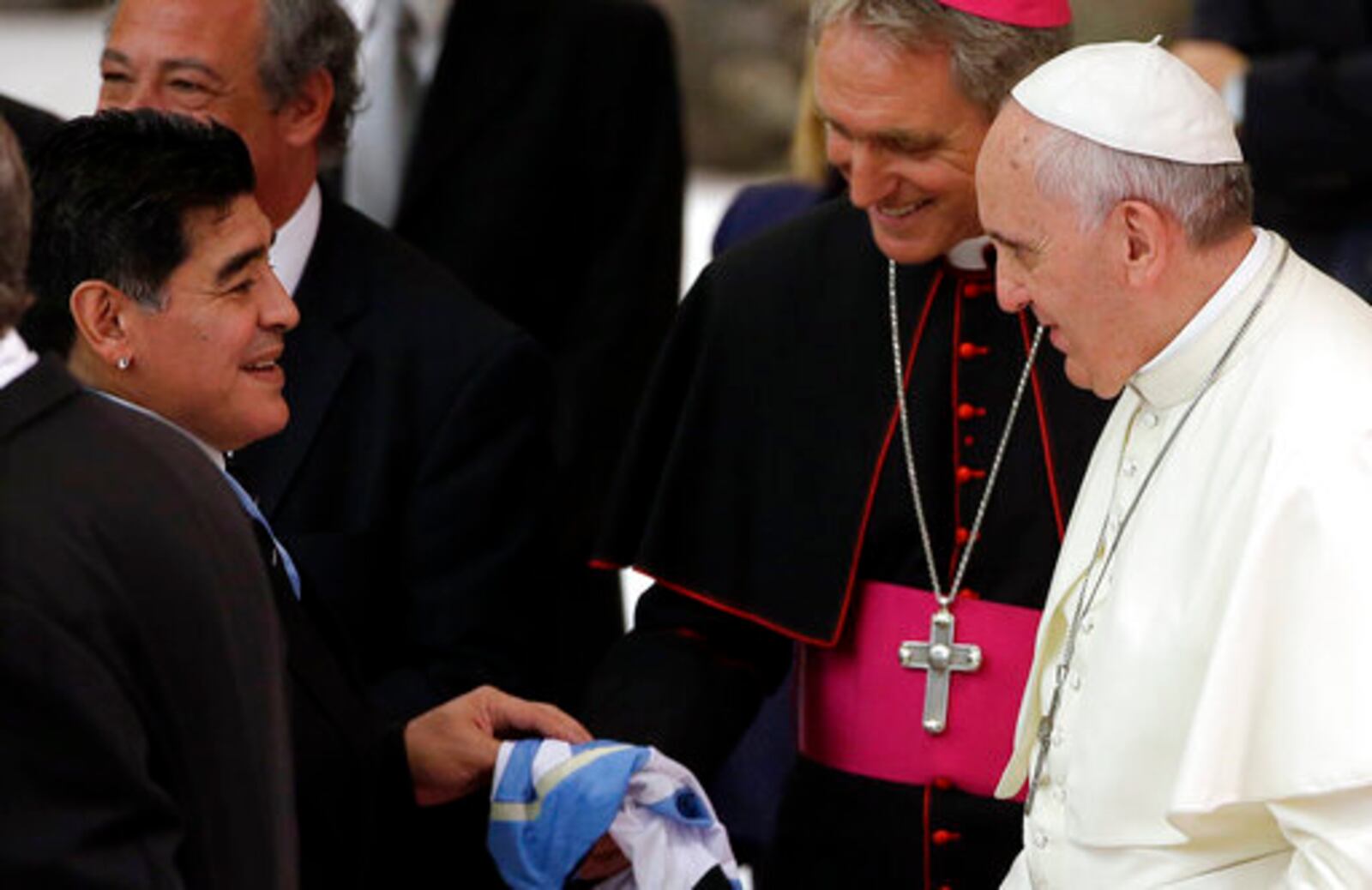 FILE - Argentine soccer legend Diego Armando Maradona, left, greets Pope Francis in the Paul VI hall at the Vatican, Monday, Sept. 1, 2014. (AP Photo/Gregorio Borgia, File)