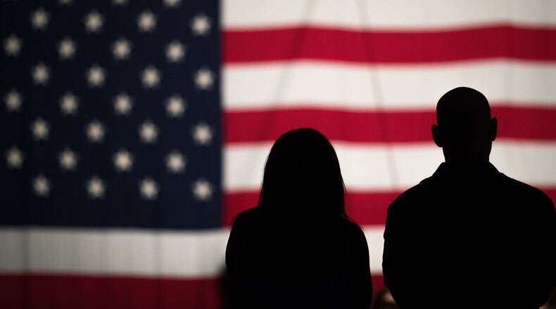 FLAG ON THE MALL--WASHINGTON, DC - MAY 27: A couple views a large American flag set up on the National Mall, May 27, 2016, in Washington, DC. Rolling Thunder members and supporters will participate in a motorcycle rally on Sunday afternoon in Washington. Rolling Thunder is an advocacy group that seeks to bring awareness to prisoners of war (POWs) and missing in action (MIA) service members of all U.S. wars. (Photo by Drew Angerer/Getty Images) ***BESTPIX***