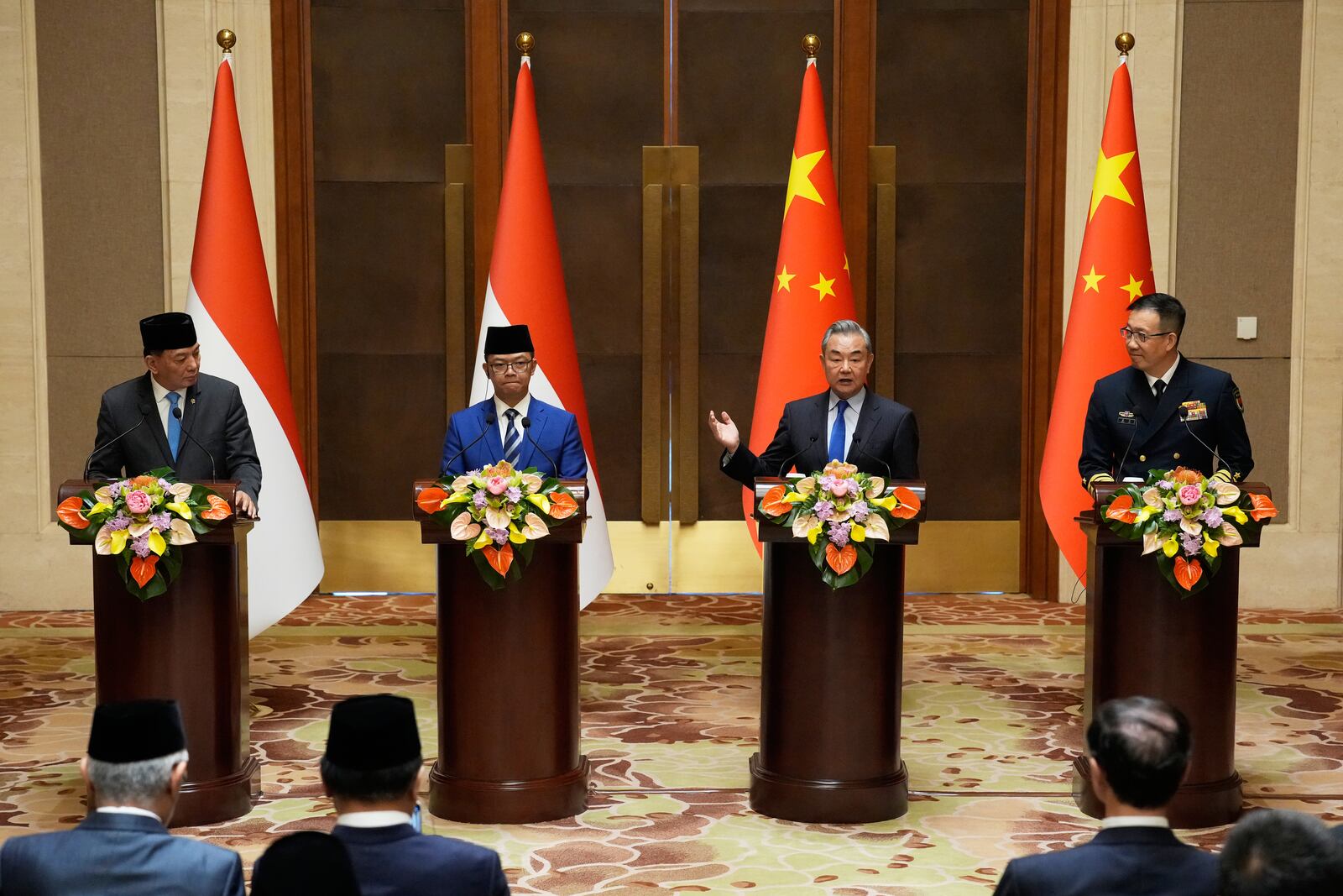 Indonesian Defense Minister Sjafrie Sjamsoeddin, left, Foreign Minister Sugiono, center left, Chinese Foreign Minister Wang Yi, center right, and Defense Minister Dong Jun attend a press briefing after the first meeting of China-Indonesia joint foreign and defense ministerial dialogue at the Diaoyutai State Guest House Monday, April 21, 2025 in Beijing, China. (Iori Sagisawa/Pool Photo via AP)