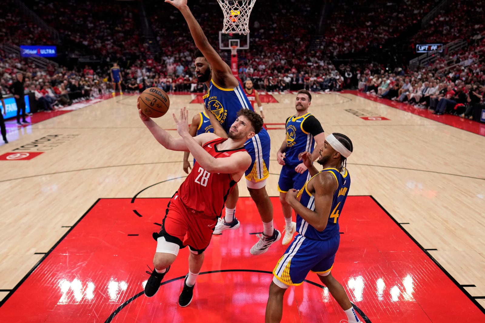 Houston Rockets center Alperen Sengun (28) shoots as Golden State Warriors forward Trayce Jackson-Davis (32) defends during the second half of Game 5 of an NBA basketball first-round playoff series, Wednesday, April 30, 2024, in Houston. (AP Photo/David J. Phillip)