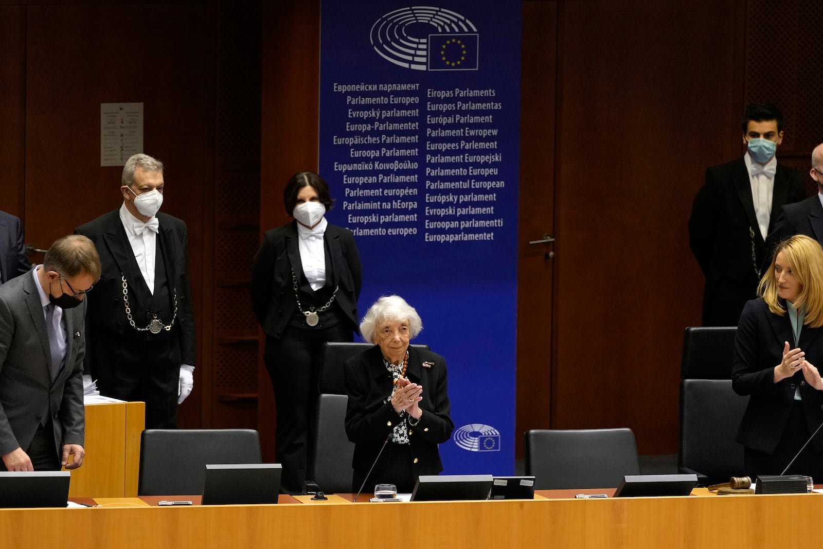 Holocaust survivor Margot Friedlander, center, stands as members of the European Parliament applaud after an address in the plenary chamber at the European Parliament in Brussels, Thursday, Jan. 27, 2022. (AP Photo/Virginia Mayo)