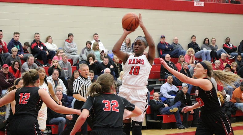 Trotwood’s Mercedes Woodward (10) shoots over Tippecanoe defenders Brooke Aselage (12), Maddie Frederick (32) and Allison Mader. Tipp defeated Trotwood 60-45. Contributed / Greg Billing
