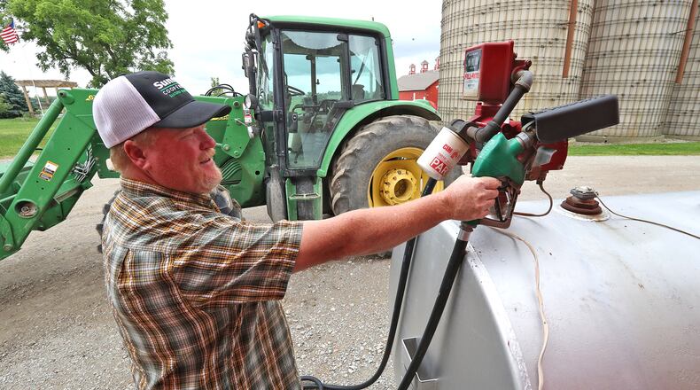 Brian Harbage fuels up one of his tractors Thursday, June 9, 2022 on his farm near South Charleston. BILL LACKEY/STAFF
