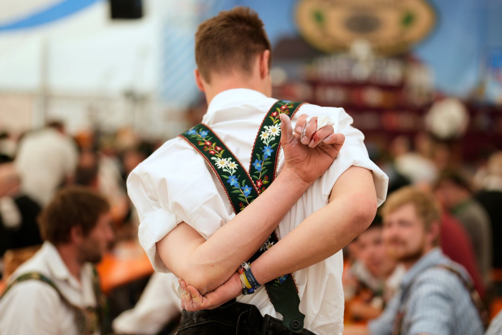 A competitor warms up for his bout while he try to pull the opponent over the table at the German Championships in Fingerhakeln or finger wrestling, in Pang, near Rosenheim, Germany, Sunday, April 27, 2025. (AP Photo/Matthias Schrader)