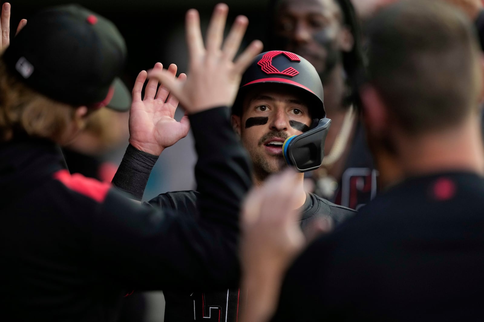Cincinnati Reds' Spencer Steer celebrates in the dugout after scoring off a double hit by Tyler Stephenson in the fifth inning of a baseball game Chicago Cubs, Friday, May 23, 2025, in Cincinnati. (AP Photo/Carolyn Kaster)