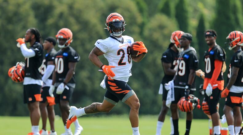 Cincinnati Bengals' Joe Mixon carries the ball during NFL football practice in Cincinnati, Wednesday, July 28, 2021. (AP Photo/Aaron Doster)