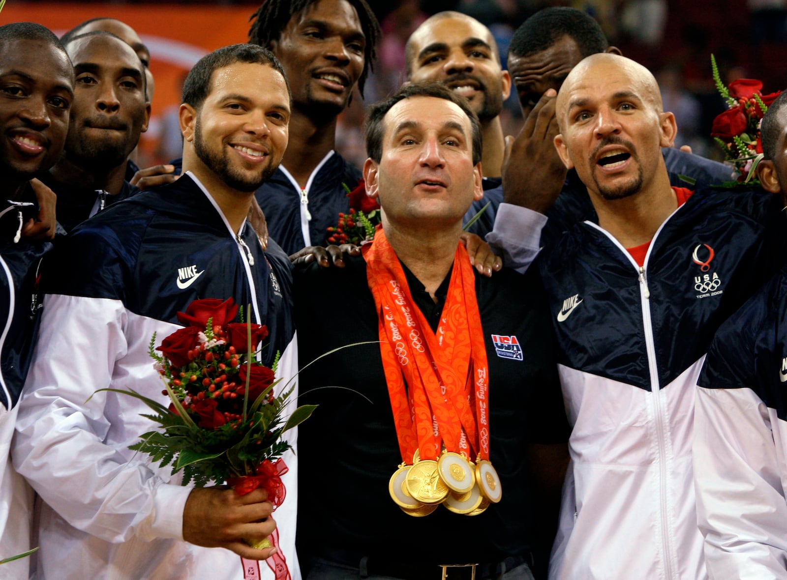 FILE - USA's coach Mike Krzyzewski, center, wears his players gold medals as they celebrate after beating Spain 118-107 in the men's gold medal basketball game at the Beijing 2008 Olympics in Beijing, Sunday, Aug. 24, 2008. Flanking Krzyzewski is Deron Williams, left, and Jason Kidd. (AP Photo/Dusan Vranic, File)