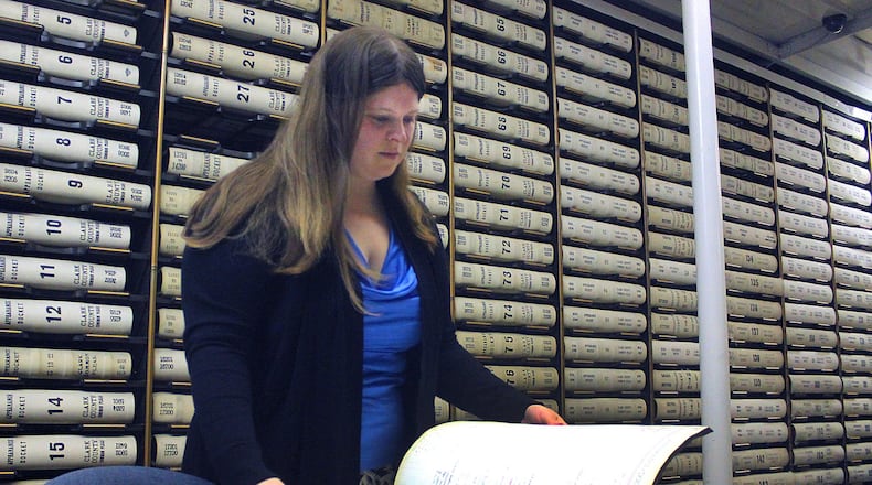 Clark County Common Pleas Clerk Melissa Tuttle looks at old case files in the clerks office. JEFF GUERINI/STAFF