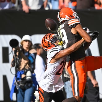 Cincinnati Bengals cornerback DJ Turner II (20) commits pass interference against Cleveland Browns wide receiver Cedric Tillman (19) in the end zone in the first half of an NFL football game, Sunday, Oct. 20, 2024, in Cleveland. (AP Photo/David Richard)