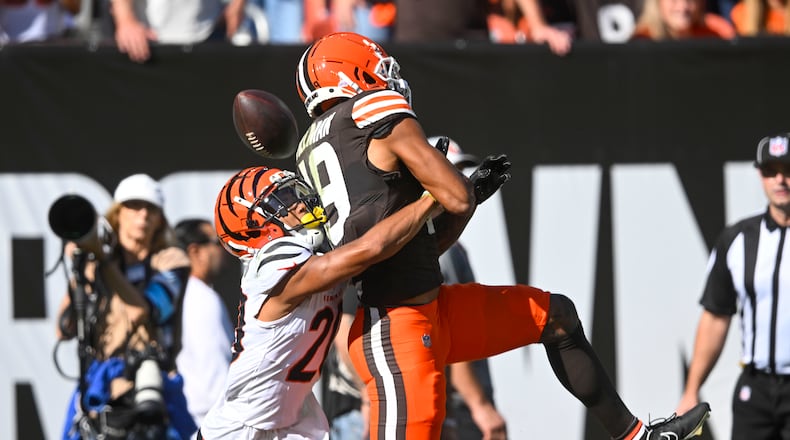 Cincinnati Bengals cornerback DJ Turner II (20) commits pass interference against Cleveland Browns wide receiver Cedric Tillman (19) in the end zone in the first half of an NFL football game, Sunday, Oct. 20, 2024, in Cleveland. (AP Photo/David Richard)