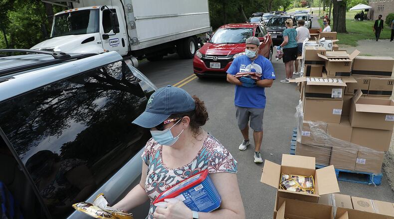 Second Harvest Food Bank has been selected to participate in a national pilot program to address food insecurity. The food bank is working to meet increased demand from families affected by the pandemic and relies on volunteers for help like those with the Springfield Arts Council who helped distribute food at Veteran’s Park this summer. BILL LACKEY/STAFF