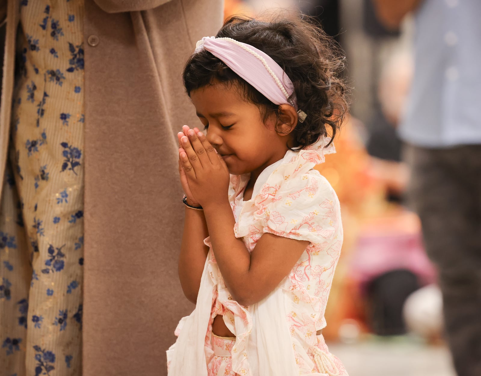 A worshiper prays in front of a murti during a Diwali service at Hindu Temple of Dayton on Tuesday, Oct. 20 in Beavercreek. BRYANT BILLING/STAFF