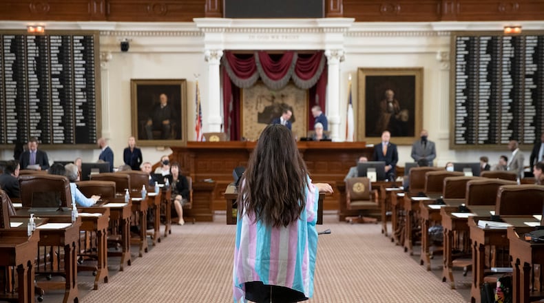 State Rep. Mary González, D - Clint, wears the colors of the transgender pride flag while speaking against House Bill 25, that limits the participation of transgender athletes in public school sports, in the House Chamber at the Capitol in Austin, Texas, on Thursday Oct. 14, 2021. (Jay Janner /Austin American-Statesman via AP)