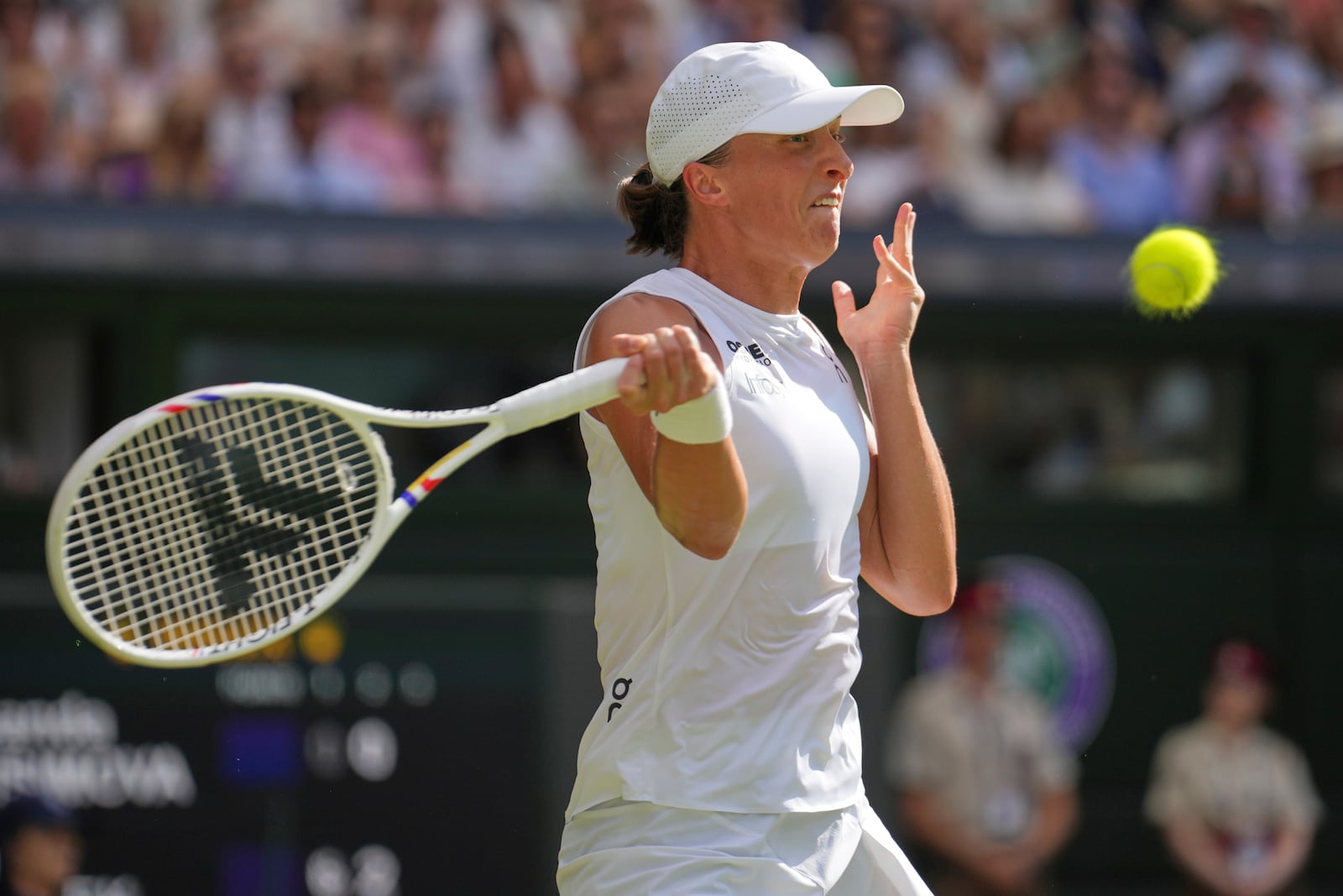 Poland's Iga Swiatek returns to Amanda Anisimova of the U.S. during the women's singles final at the Wimbledon Tennis Championships in London, Saturday, July 12, 2025. (AP Photo/Kin Cheung)