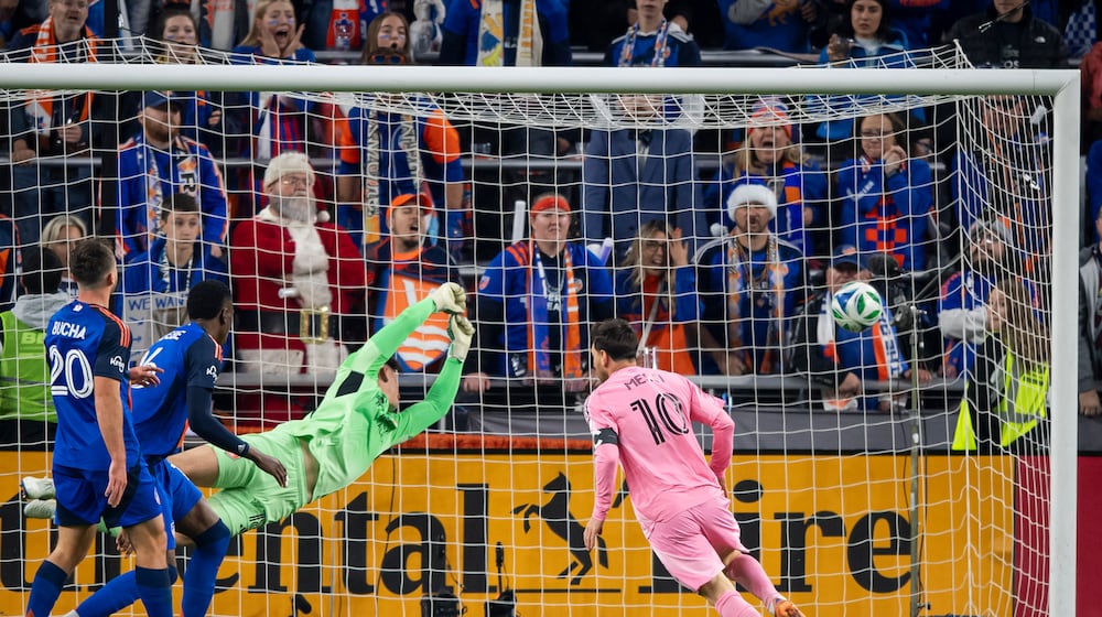 Inter Miami forward Lionel Messi (10) scores as FC Cincinnati goalkeeper Roman Celentano, third from left, tries to defend during the first half of MLS soccer's Eastern Conference semifinal Sunday, Nov. 23, 2025, in Cincinnati. (AP Photo/Tanner Pearson)