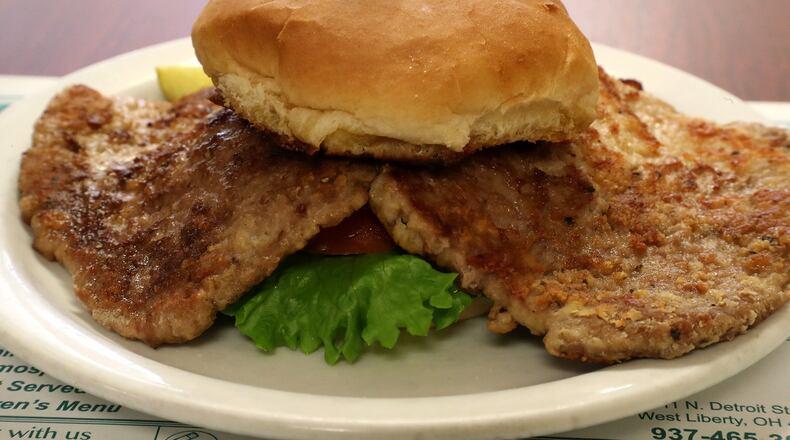 The Country Fried Tenderloin Sandwich at the Liberty Gathering Place overflows the bun. BILL LACKEY/STAFF