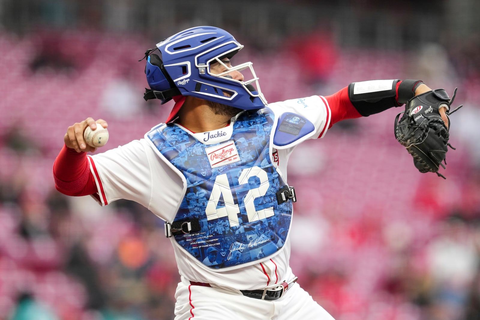 Cincinnati Reds catcher Jose Trevino warms up while wearing catching gear in honor of Jackie Robinson Day during the second inning of a baseball game against the Seattle Mariners, Tuesday, April 15, 2025, in Cincinnati. (AP Photo/Jeff Dean)