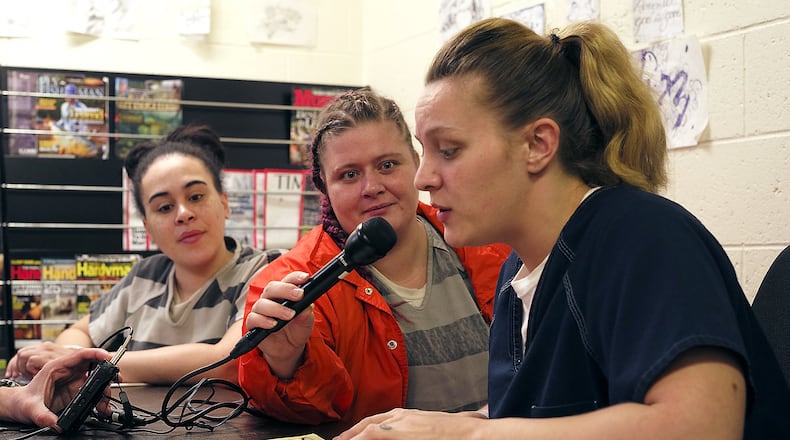 Megan Parker, an inmate in the Clark County Jail, reads from a children’s book as her voice is recorded for her children at home. Nickie Nickels, also an inmate, holds the microphone for her, and inmate Kiersten Hayes waits her turn to record in the jail’s library. BILL LACKEY/STAFF