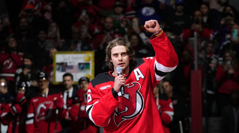 New Jersey Devils' Jack Hughes (86) speaks to fans before an NHL hockey game against the Buffalo Sabres Wednesday, Feb. 25, 2026, in Newark, N.J. (AP Photo/Frank Franklin II)