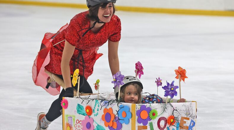 Jack and Sylvia Driscoll get pushed by their mother, Mollie, in their Flower Power bobsled during the Cardboard Classic Bobsled Races at The Chiller Ice Skating Rink last year. BILL LACKEY/STAFF