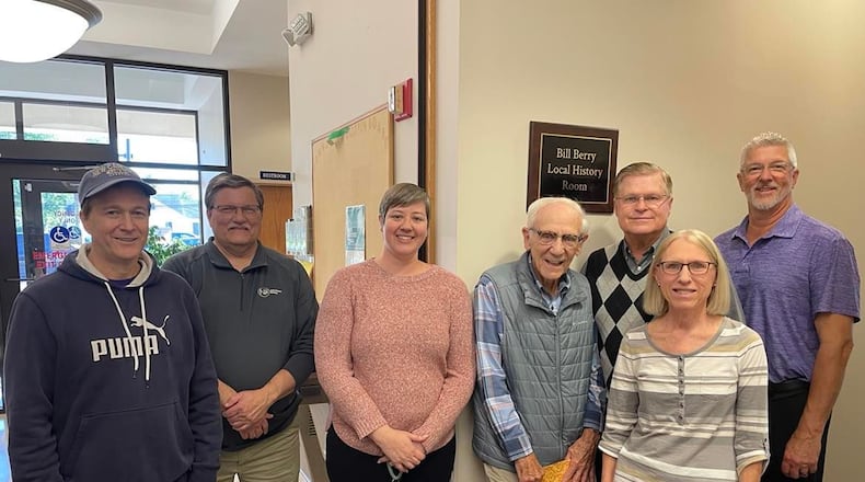 With the sign, Board of Directors Secretary Dave McWhorter, President Carl Gilbert, Library Director Beth Freeman, Bill Berry, Clark County Commissioner and Board Member Lowell McGlothin, Board Vice President Brian Macy, and in front Library Fiscal Officer Carol Ruschau. Photo by Pam Cottrel