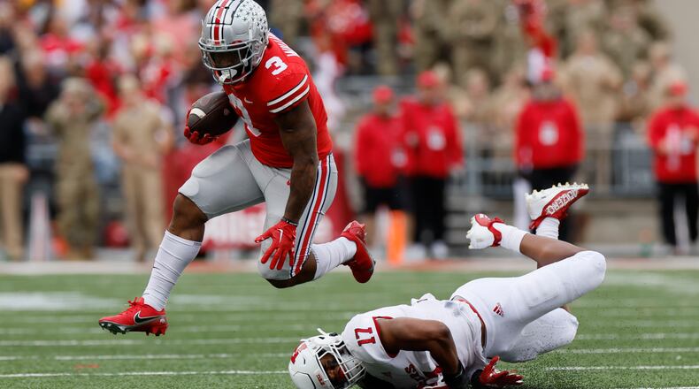 Ohio State running back Miyan Williams, left, leaps over Rutgers linebacker Deion Jennings during the first half of an NCAA college football game, Saturday, Oct. 1, 2022, in Columbus, Ohio. (AP Photo/Jay LaPrete)