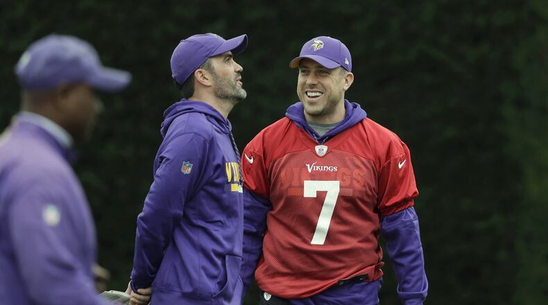 FILE - In this Oct. 26, 2017, file photo, Minnesota Vikings quarterback Case Keenum talks to quarterbacks coach Kevin Stefanski during an NFL walkthrough practice session at Syon House in Syon Park, south west London. Keenum’s NFL journey is reuniting him with a coach who brought out the best in the quarterback. Keenum officially signed his three-year, $18 million contract Tuesday, March 24, 2020, with the Cleveland Browns, who are bringing him in to help Baker Mayfield and give new coach Kevin Stefanski a security blanket in case things don’t go as planned. (AP Photo/Matt Dunham, File)