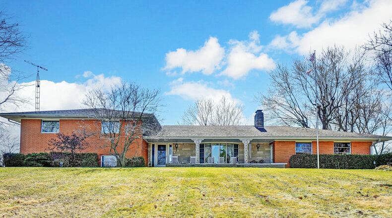 The brick, executive style quad level sits on an 11 plus acre lot in the Tecumseh school district.