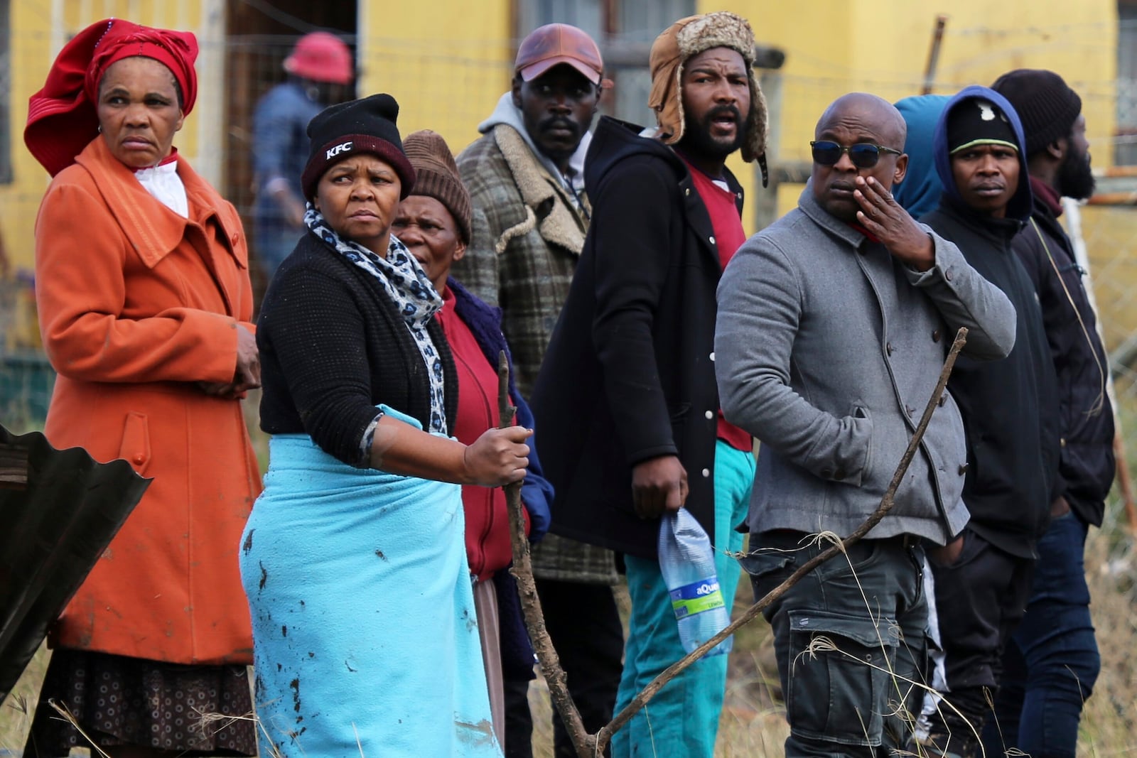 Community members and families watch as rescue workers recover bodies after floods swept through the area in Mthatha, South Africa, Wednesday, June 11, 2025. (AP Photo/Hoseya Jubase)
