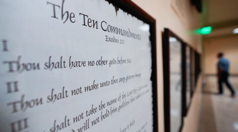 FILE - A copy of the Ten Commandments is posted along with other historical documents in a hallway of the Georgia Capitol, June 20, 2024, in Atlanta. (AP Photo/John Bazemore, File)