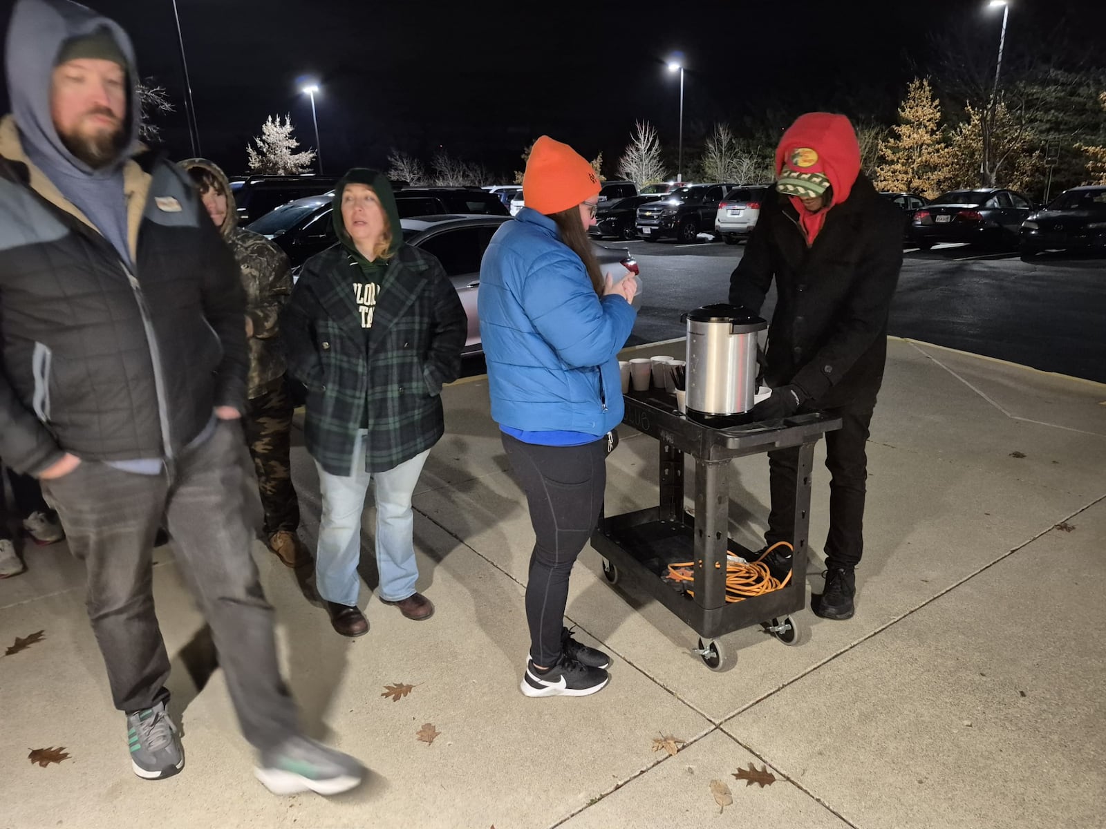 People line up for free hot chocolate while waiting for the Centerville Cabela's store to open on Black Friday. MICHAEL KURTZ / STAFF